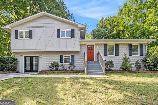 3995 Emerald N Dr, Decatur, GA 30035 - tri-level home with brick siding, a front yard, board and batten siding, and french doors