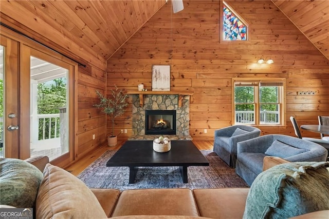 living room with wood ceiling, vaulted ceiling, wood finished floors, and a wealth of natural light