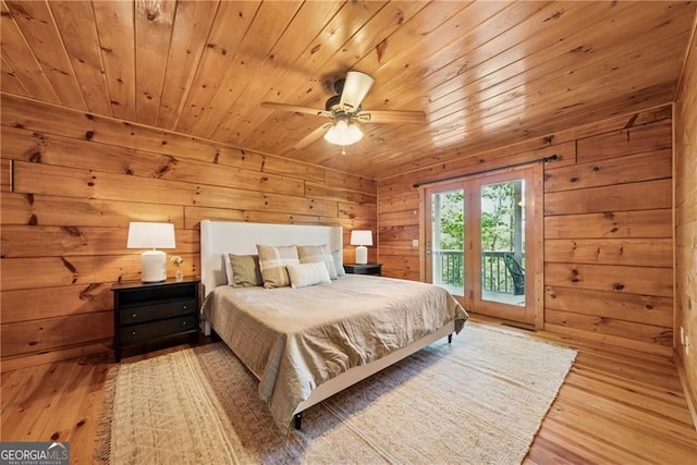 bedroom featuring hardwood / wood-style flooring, wooden ceiling, access to exterior, and wooden walls