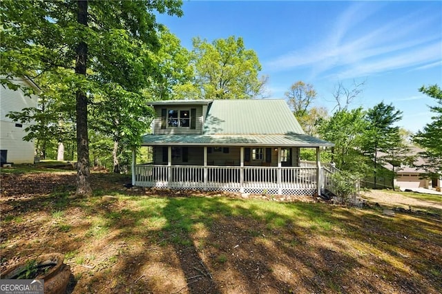 farmhouse with a porch and metal roof