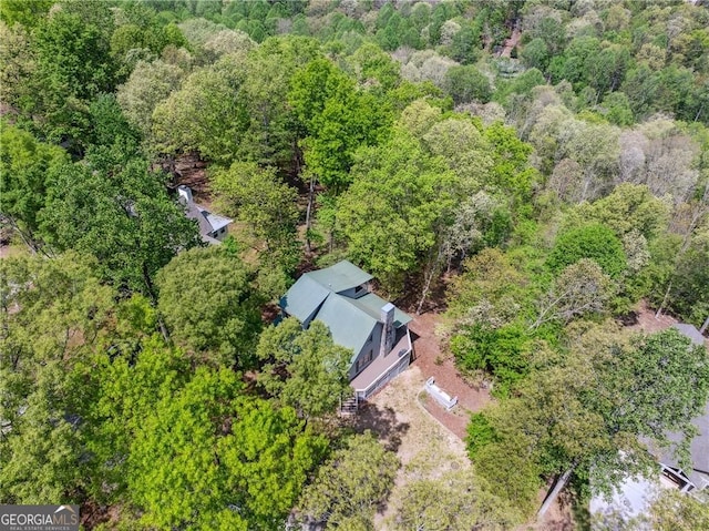 drone / aerial view with a wooded view