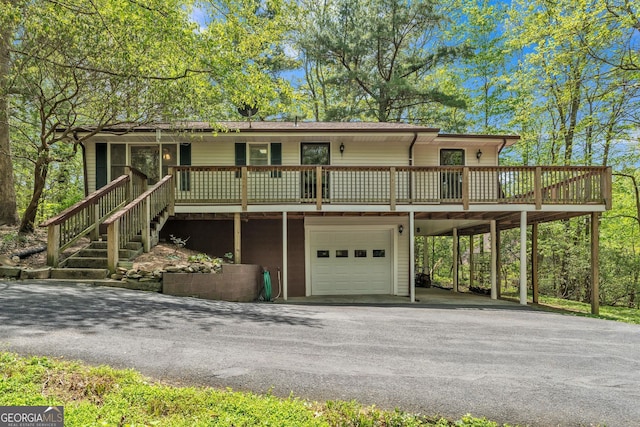 view of front of property featuring a garage, driveway, and a carport