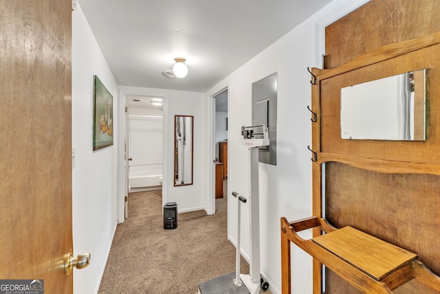 hall featuring carpet floors and baseboards