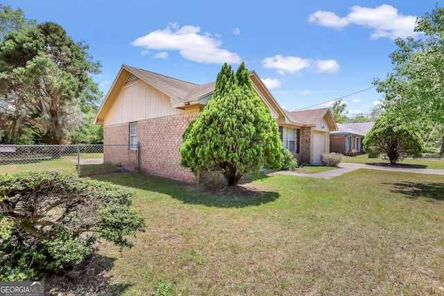 767 Madison Dr, Hinesville, GA 31313 - view of home's exterior featuring brick siding, a yard, a garage, and fence