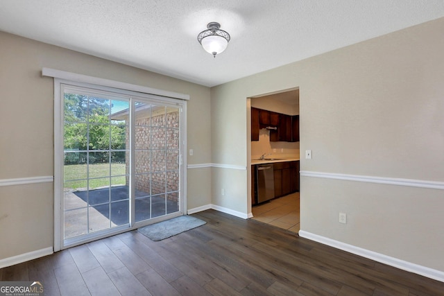 767 Madison Dr, Hinesville, GA 31313 - unfurnished dining area with baseboards, wood finished floors, and a textured ceiling