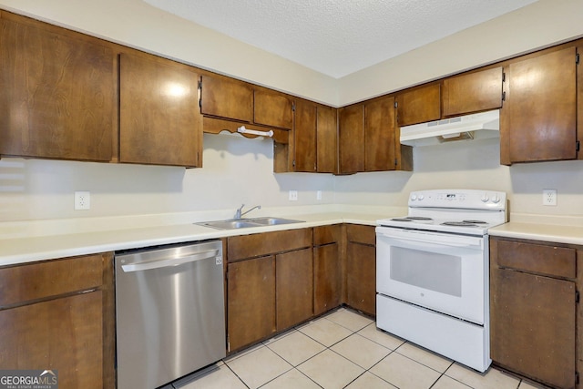 767 Madison Dr, Hinesville, GA 31313 - kitchen with white electric range oven, stainless steel dishwasher, a sink, light countertops, and under cabinet range hood