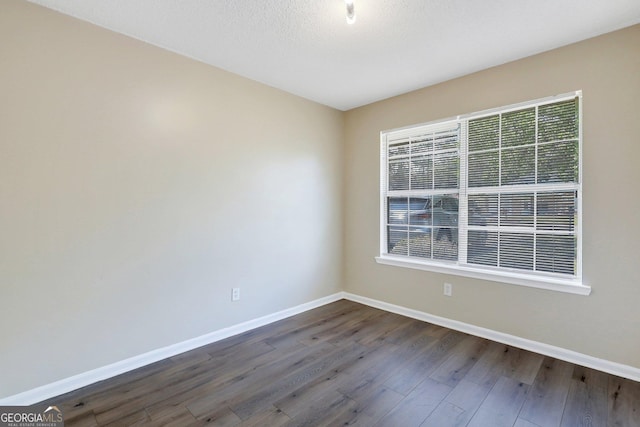 767 Madison Dr, Hinesville, GA 31313 - empty room with dark wood-type flooring and baseboards