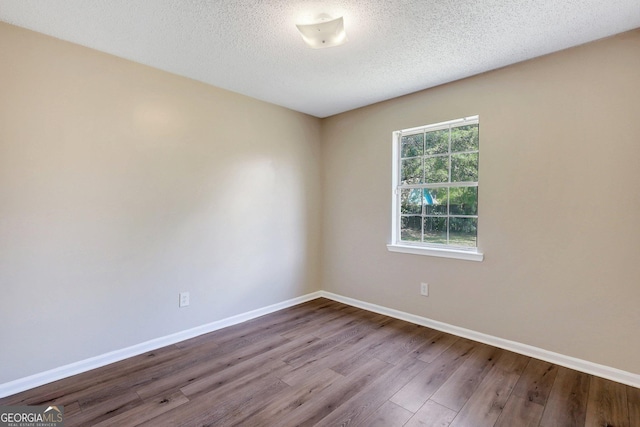 767 Madison Dr, Hinesville, GA 31313 - unfurnished room featuring baseboards, wood finished floors, and a textured ceiling