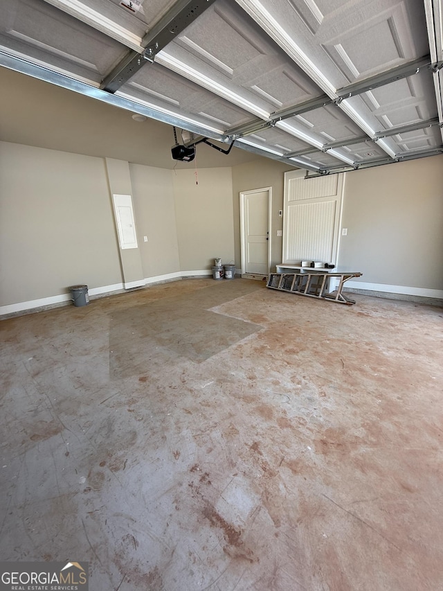 garage with baseboards and a garage door opener