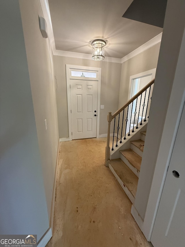 foyer with unfinished concrete floors, crown molding, baseboards, stairs, and a notable chandelier