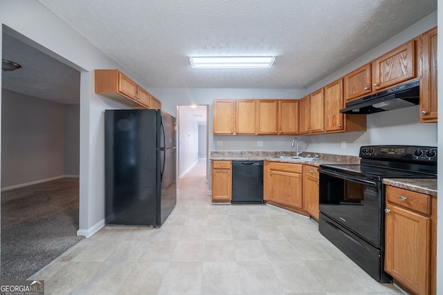 kitchen featuring a textured ceiling, a sink, baseboards, black appliances, and under cabinet range hood