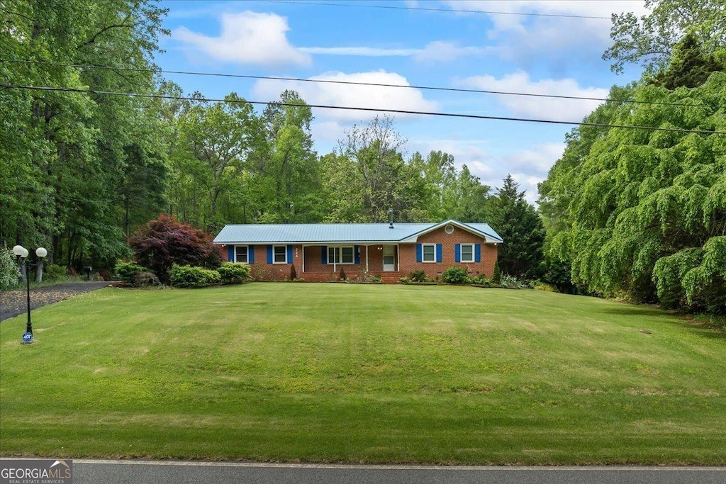 725 School Rd, Hampton, GA 30228 - ranch-style house featuring a front lawn and brick siding