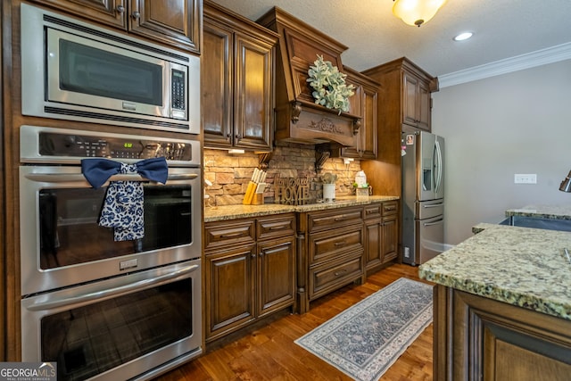 kitchen with crown molding, appliances with stainless steel finishes, tasteful backsplash, and dark wood-style flooring