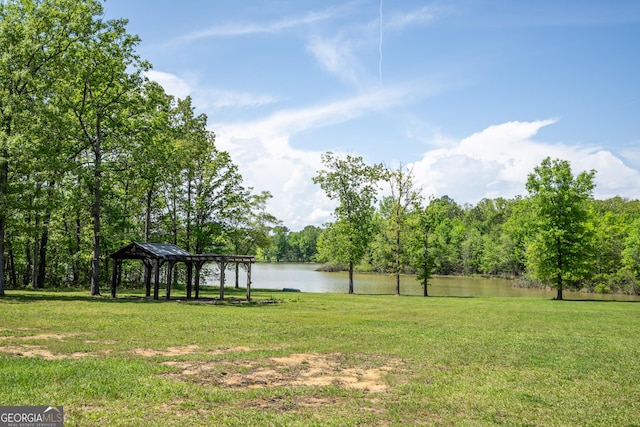 view of yard featuring a gazebo and a water view