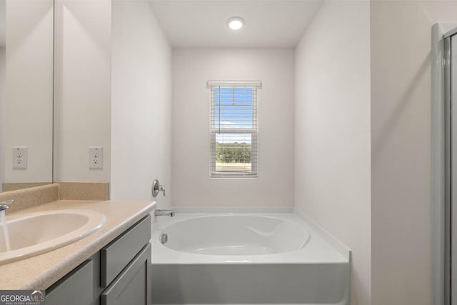 bathroom featuring a bath and vanity