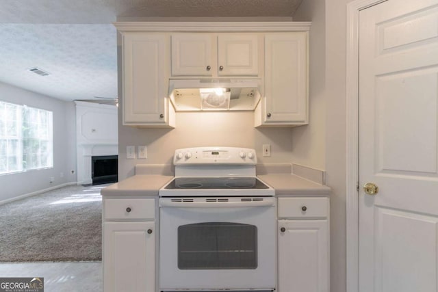 kitchen with open floor plan, visible vents, under cabinet range hood, light countertops, and white range with electric stovetop