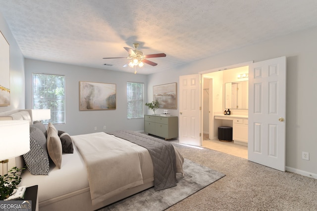 bedroom featuring connected bathroom, ceiling fan, carpet, and multiple windows