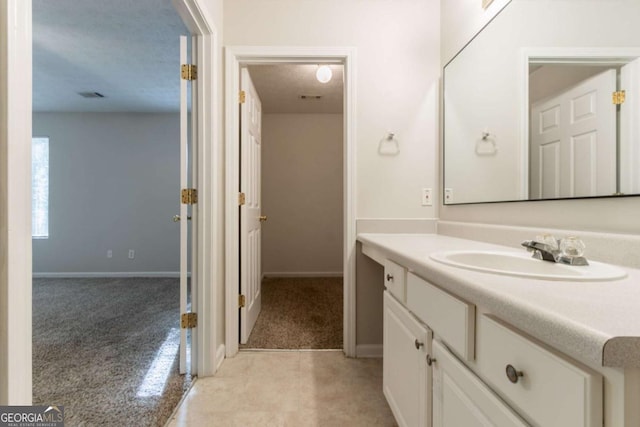 bathroom with vanity, baseboards, and visible vents