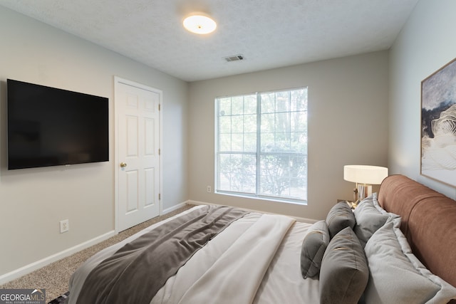 bedroom with carpet flooring, multiple windows, visible vents, and baseboards
