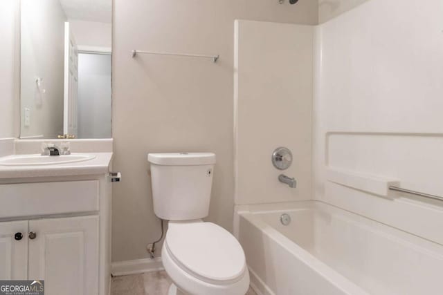 bathroom with toilet, baseboards, vanity, and tub / shower combination