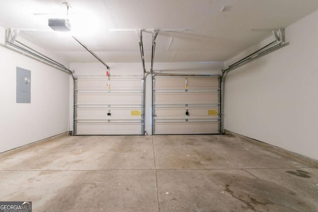 garage with electric panel and a garage door opener