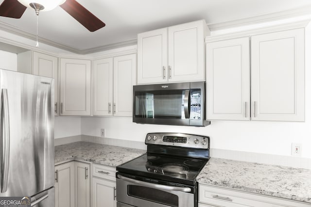 kitchen featuring white cabinets, ceiling fan, light stone counters, and stainless steel appliances