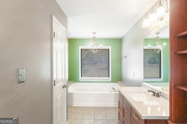 bathroom with tile patterned floors, a garden tub, and an inviting chandelier
