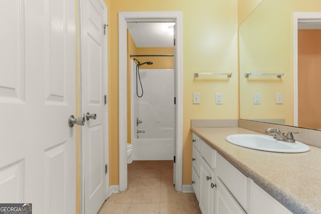 full bath featuring toilet, tile patterned floors, shower / bathing tub combination, vanity, and baseboards