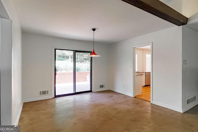 unfurnished room featuring baseboards, visible vents, and finished concrete flooring