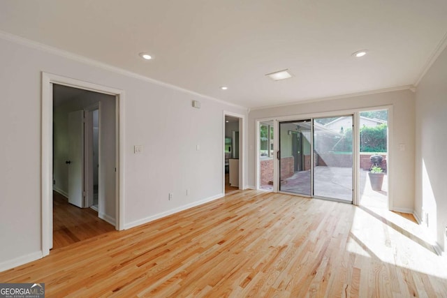 empty room with recessed lighting, light wood finished floors, crown molding, and baseboards
