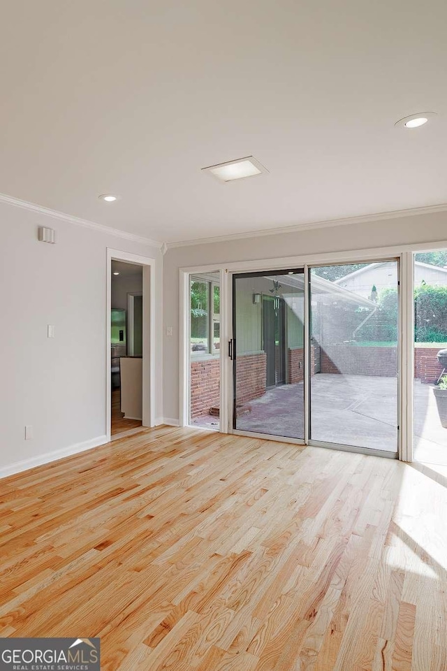 spare room with baseboards, ornamental molding, wood finished floors, and recessed lighting