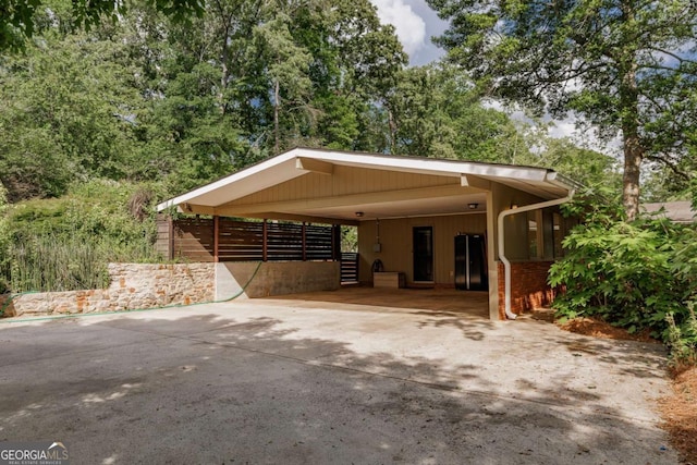 exterior space with driveway and an attached carport