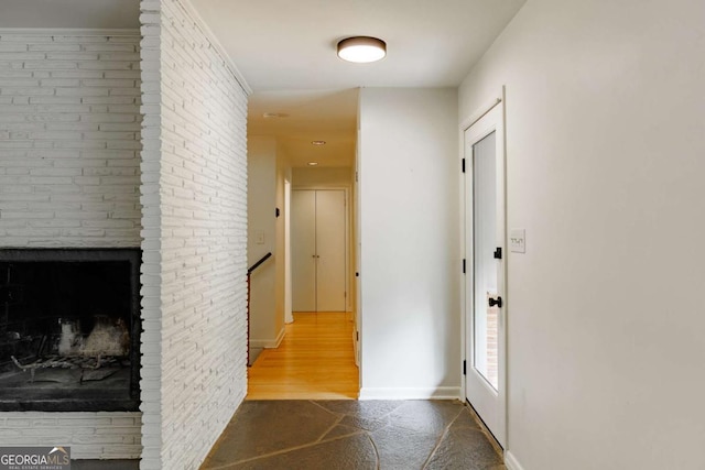hallway with baseboards and an upstairs landing