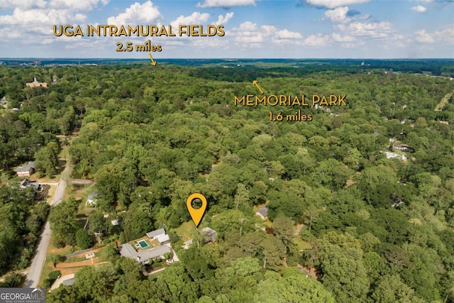 aerial view featuring a wooded view