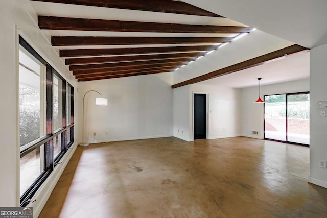 spare room with lofted ceiling with beams, concrete floors, visible vents, and baseboards