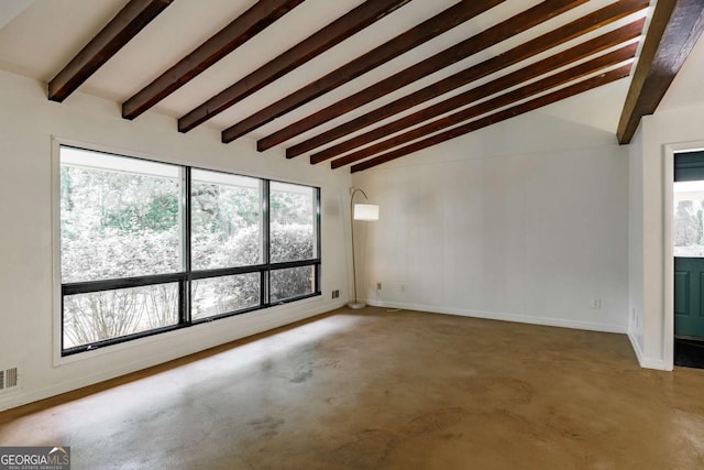 unfurnished room with visible vents, baseboards, vaulted ceiling with beams, and concrete flooring