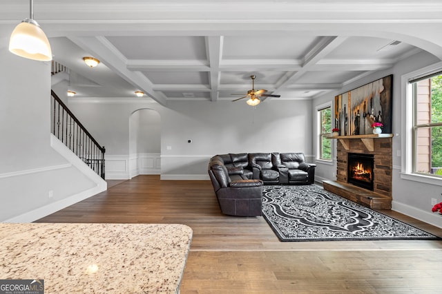 279 Sturry Dr, Mcdonough, GA 30252 - living room featuring arched walkways, wood finished floors, a stone fireplace, and ceiling fan