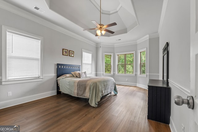 279 Sturry Dr, Mcdonough, GA 30252 - bedroom featuring a tray ceiling, wood finished floors, visible vents, crown molding, and baseboards
