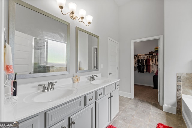 279 Sturry Dr, Mcdonough, GA 30252 - bathroom featuring a bath, baseboards, a sink, and double vanity