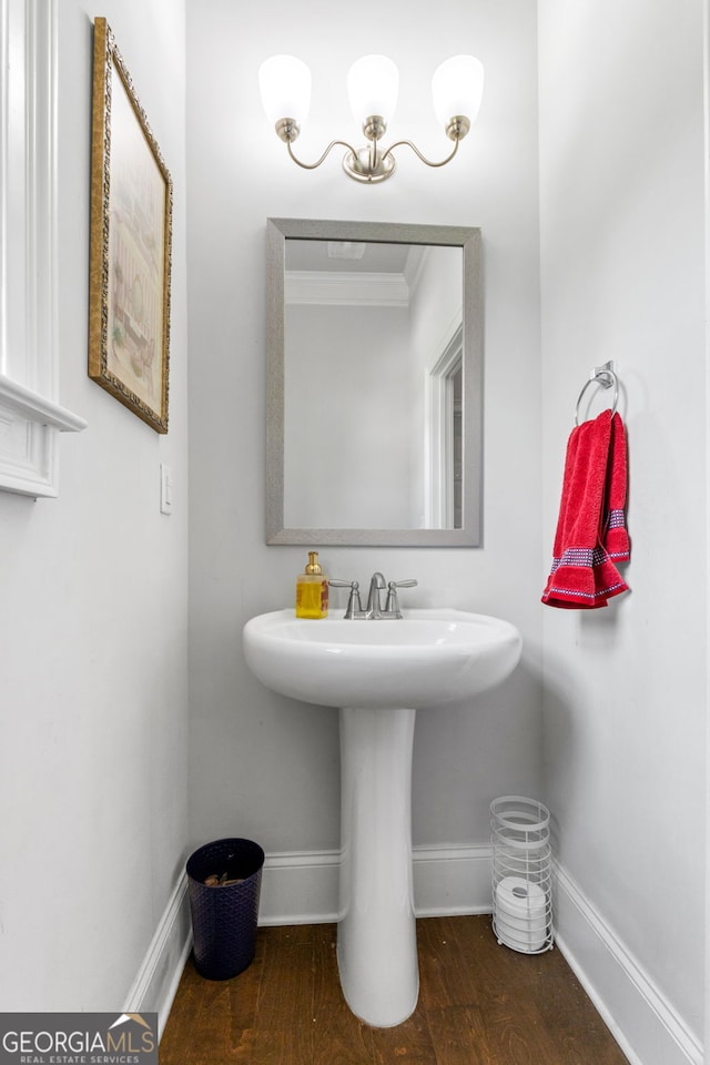 279 Sturry Dr, Mcdonough, GA 30252 - bathroom featuring baseboards, crown molding, wood finished floors, and a sink