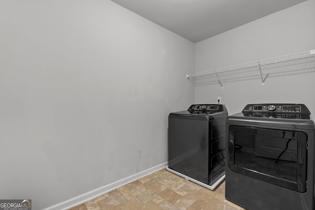 279 Sturry Dr, Mcdonough, GA 30252 - laundry room featuring washing machine and dryer, baseboards, stone finish floor, and laundry area