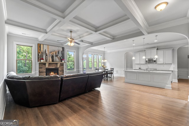 279 Sturry Dr, Mcdonough, GA 30252 - living room with a wealth of natural light, a fireplace, wood finished floors, and arched walkways