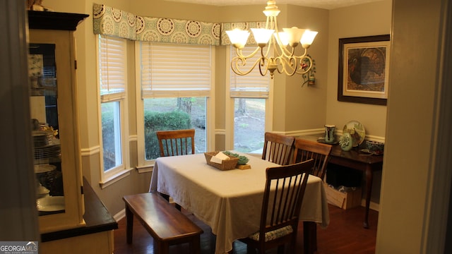 dining room featuring an inviting chandelier and dark wood finished floors