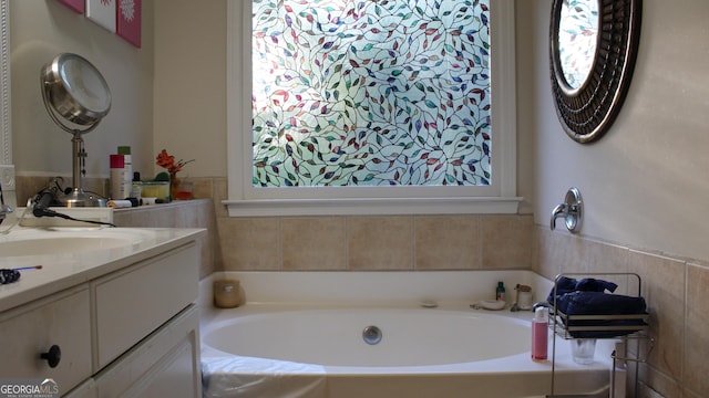 bathroom featuring a garden tub and vanity