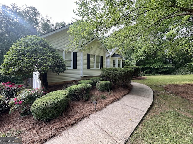 view of side of property with a lawn