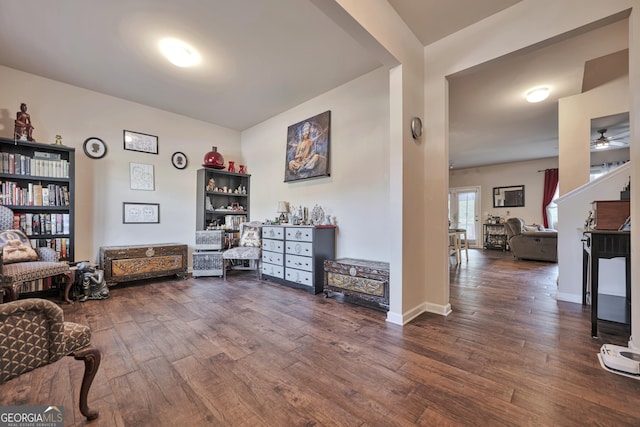 sitting room with dark wood-style flooring, ceiling fan, and baseboards