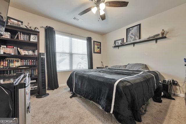 carpeted bedroom featuring visible vents, ceiling fan, and baseboards