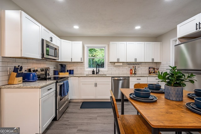 831 Catherine St, Forest Park, GA 30297 - kitchen featuring white cabinets, stainless steel appliances, recessed lighting, and a sink