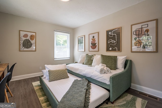 831 Catherine St, Forest Park, GA 30297 - bedroom featuring baseboards, wood finished floors, and visible vents