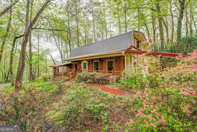 63 Eagle Chase Cir, Dillard, GA 30537 - view of front of house with covered porch, a metal roof, and a gambrel roof